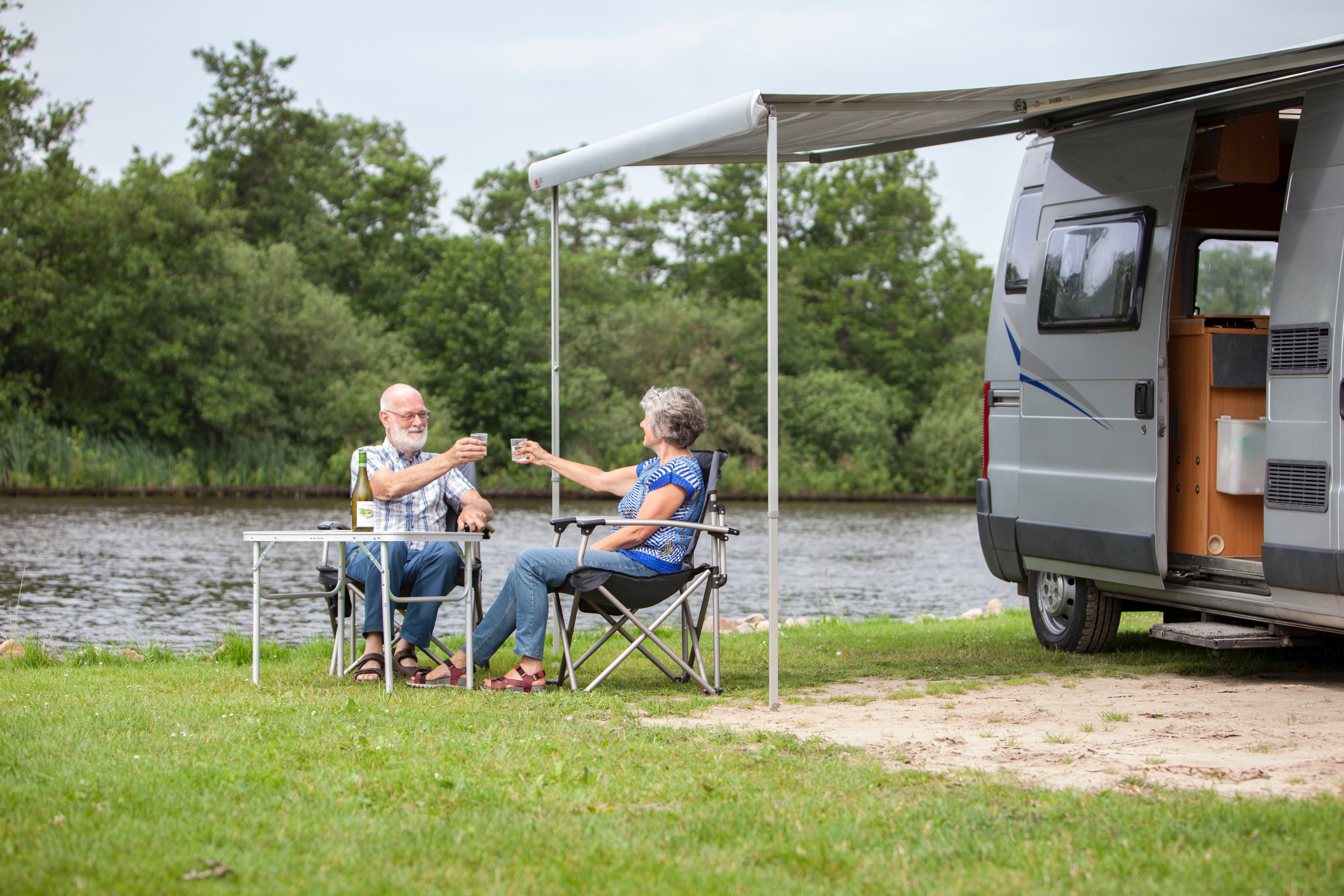 mature-couple-sitting-in-a-campsite-considering-renting-out-their-campervan-or-motorhome